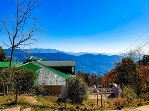 a view of the mountains from the top of a hill