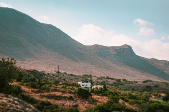 a house in the middle of a mountain range