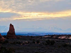 A large rock formation in the middle of a desert